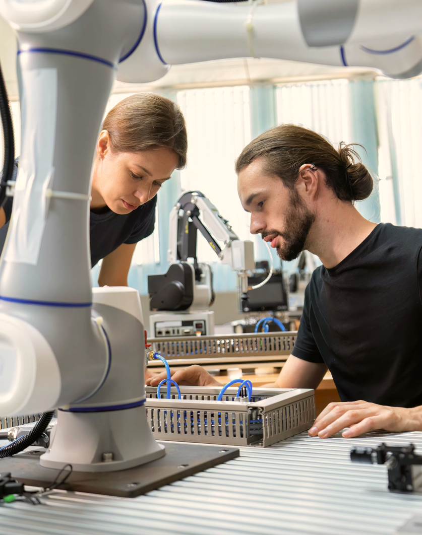 Two engineers working on robotics in a lab environment